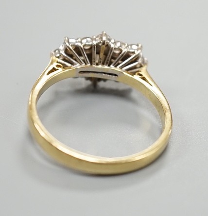 A modern 18ct gold and diamond cluster dress ring, size P, gross weight 4.2 grams, set with round and baguette cut stones.